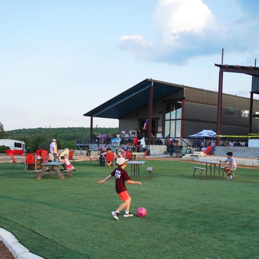 New turf areas for seating and play at Iron Wolf Ranch and Distillery