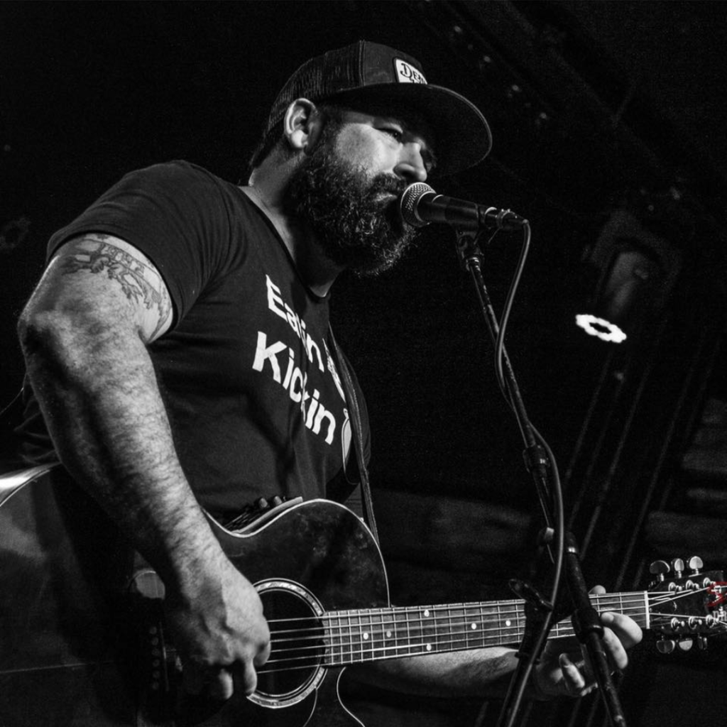 Singer Denny Herrin performing with a guitar